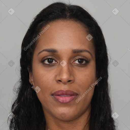 Joyful black adult female with long  brown hair and brown eyes