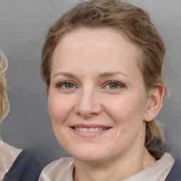 Joyful white adult female with medium  brown hair and blue eyes