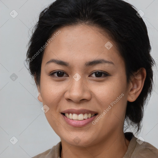 Joyful latino young-adult female with medium  brown hair and brown eyes