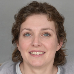 Joyful white young-adult female with medium  brown hair and blue eyes