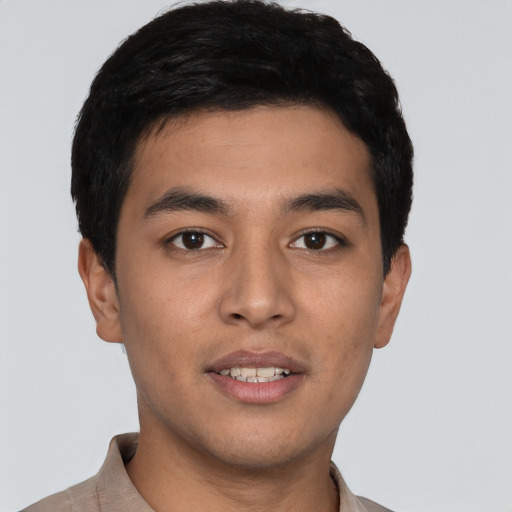 Joyful latino young-adult male with short  black hair and brown eyes