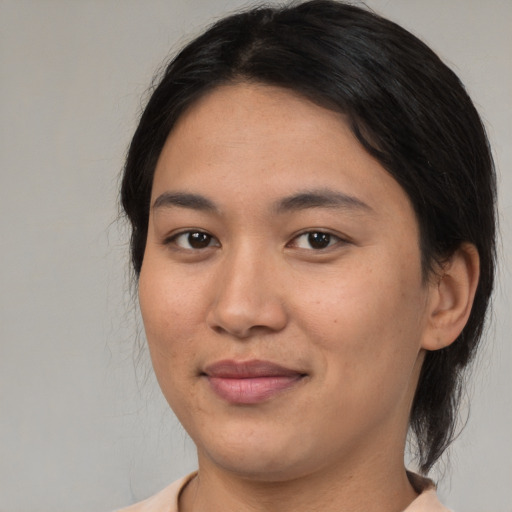 Joyful asian young-adult female with medium  brown hair and brown eyes