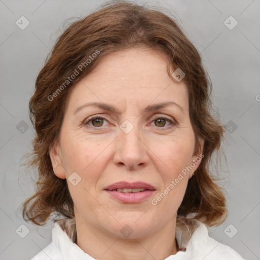 Joyful white adult female with medium  brown hair and green eyes