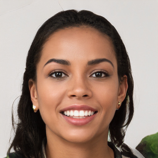 Joyful latino young-adult female with long  brown hair and brown eyes