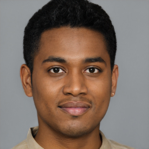 Joyful black young-adult male with short  black hair and brown eyes