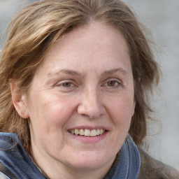 Joyful white adult female with medium  brown hair and blue eyes