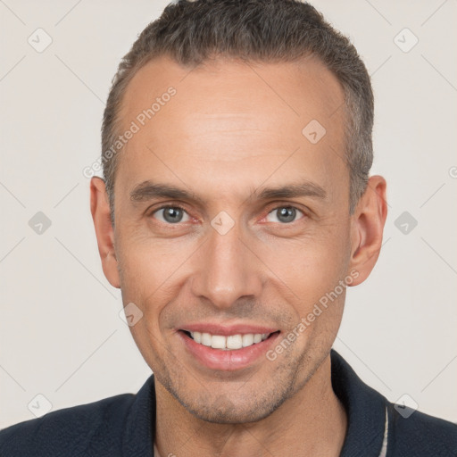 Joyful white adult male with short  brown hair and brown eyes