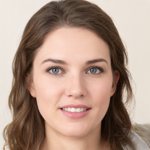 Joyful white young-adult female with long  brown hair and green eyes