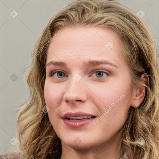 Joyful white young-adult female with long  brown hair and blue eyes