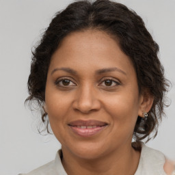 Joyful black adult female with medium  brown hair and brown eyes