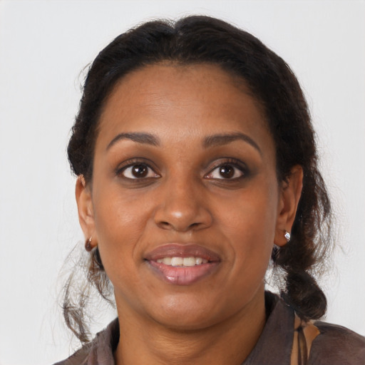 Joyful black young-adult female with medium  brown hair and brown eyes
