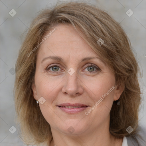 Joyful white adult female with medium  brown hair and blue eyes