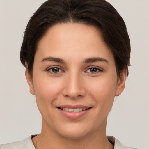 Joyful white young-adult female with short  brown hair and brown eyes