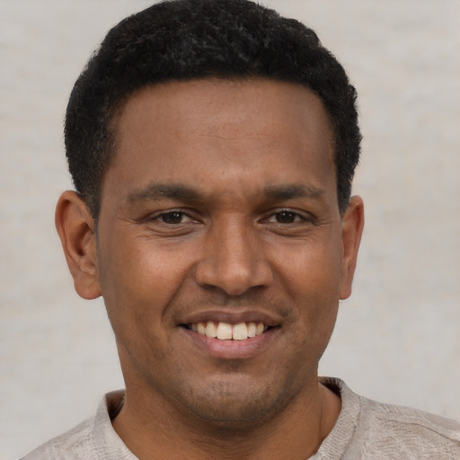 Joyful latino young-adult male with short  black hair and brown eyes