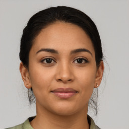 Joyful latino young-adult female with medium  brown hair and brown eyes