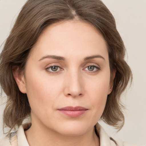 Joyful white young-adult female with medium  brown hair and green eyes