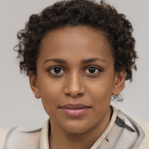 Joyful black young-adult female with short  brown hair and brown eyes