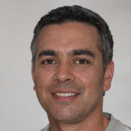 Joyful white adult male with short  black hair and brown eyes