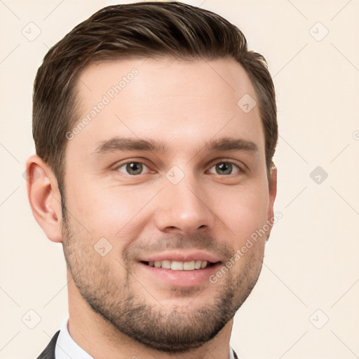 Joyful white young-adult male with short  brown hair and grey eyes