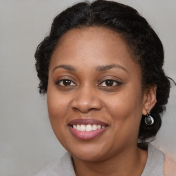 Joyful black adult female with medium  brown hair and brown eyes