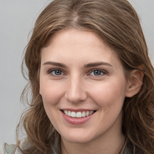 Joyful white young-adult female with long  brown hair and grey eyes