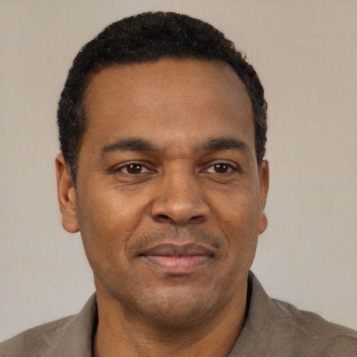 Joyful latino adult male with short  black hair and brown eyes