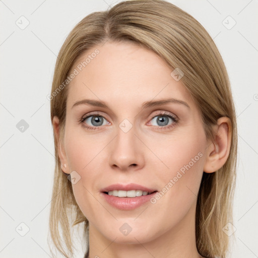 Joyful white young-adult female with long  brown hair and blue eyes