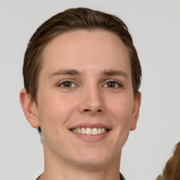 Joyful white young-adult female with short  brown hair and grey eyes