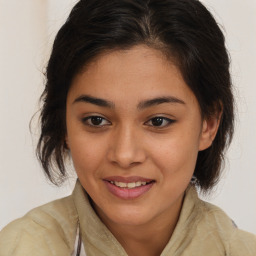 Joyful latino young-adult female with medium  brown hair and brown eyes