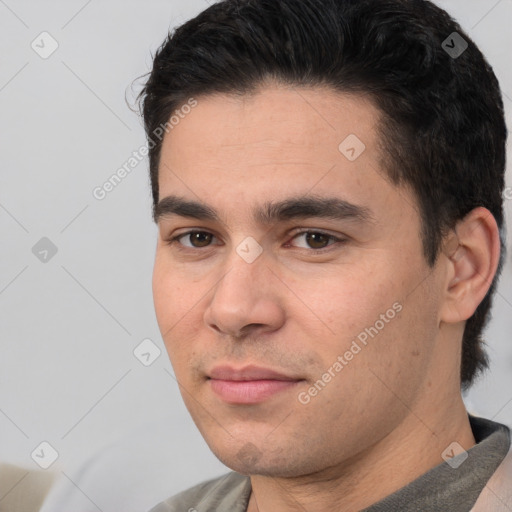 Joyful white young-adult male with short  black hair and brown eyes