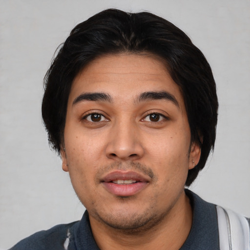 Joyful white young-adult male with short  black hair and brown eyes