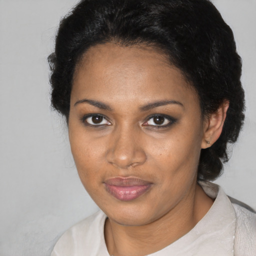 Joyful black young-adult female with short  brown hair and brown eyes
