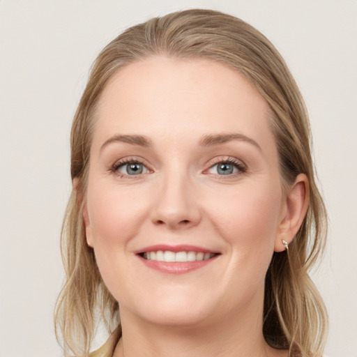 Joyful white young-adult female with long  brown hair and blue eyes