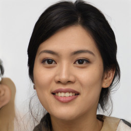 Joyful asian young-adult female with medium  black hair and brown eyes