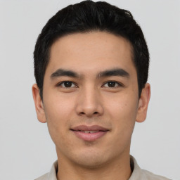 Joyful asian young-adult male with short  black hair and brown eyes