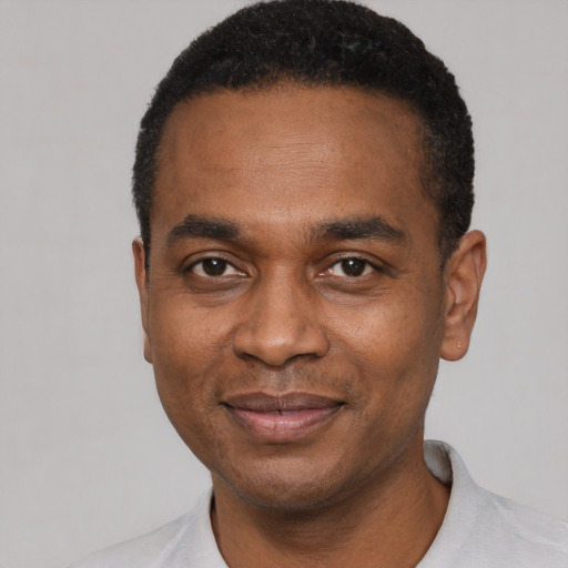Joyful latino adult male with short  black hair and brown eyes