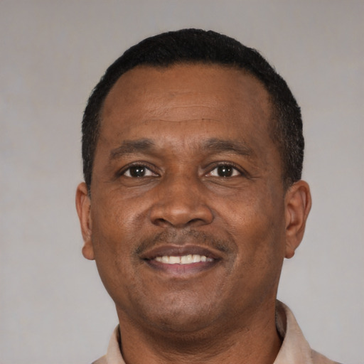 Joyful latino adult male with short  brown hair and brown eyes