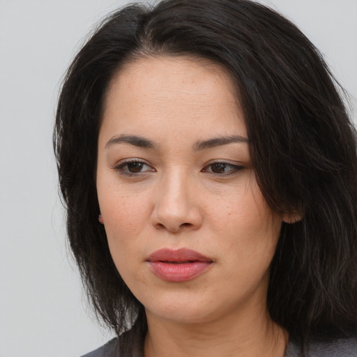 Joyful asian young-adult female with long  brown hair and brown eyes