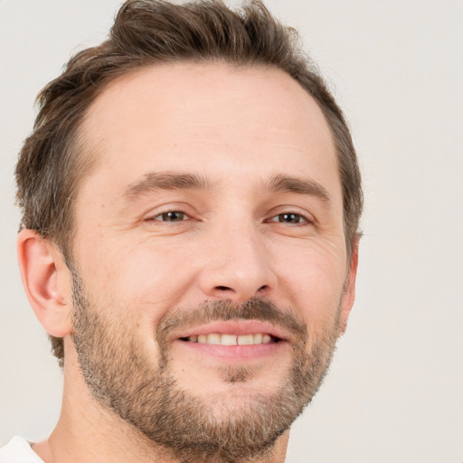 Joyful white adult male with short  brown hair and brown eyes