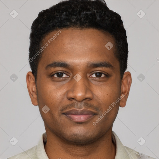 Joyful black young-adult male with short  black hair and brown eyes