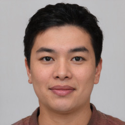 Joyful asian young-adult male with short  black hair and brown eyes