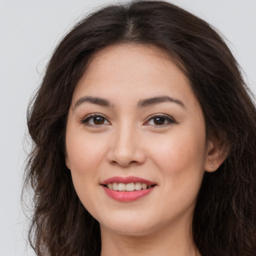 Joyful white young-adult female with long  brown hair and brown eyes