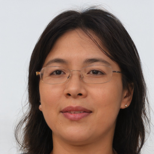 Joyful asian adult female with long  brown hair and brown eyes