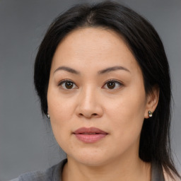 Joyful asian young-adult female with long  brown hair and brown eyes