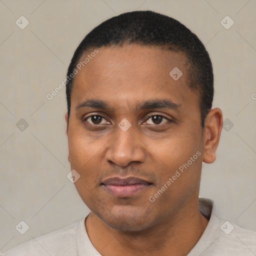 Joyful black young-adult male with short  black hair and brown eyes