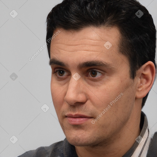 Joyful white adult male with short  brown hair and brown eyes