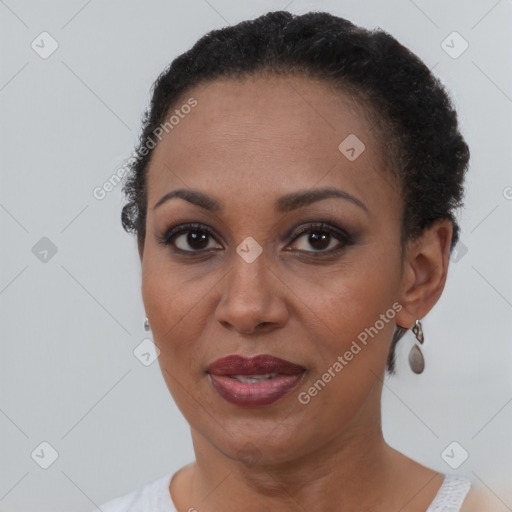 Joyful black adult female with short  brown hair and brown eyes