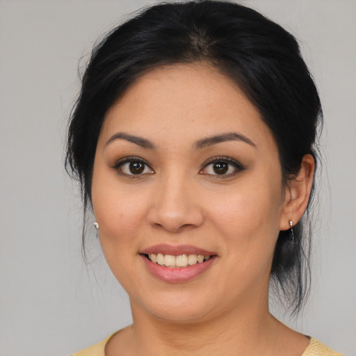 Joyful asian young-adult female with medium  brown hair and brown eyes