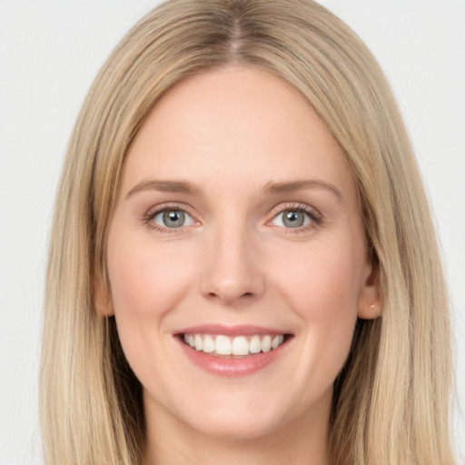 Joyful white young-adult female with long  brown hair and green eyes