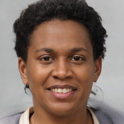 Joyful black young-adult female with short  brown hair and brown eyes